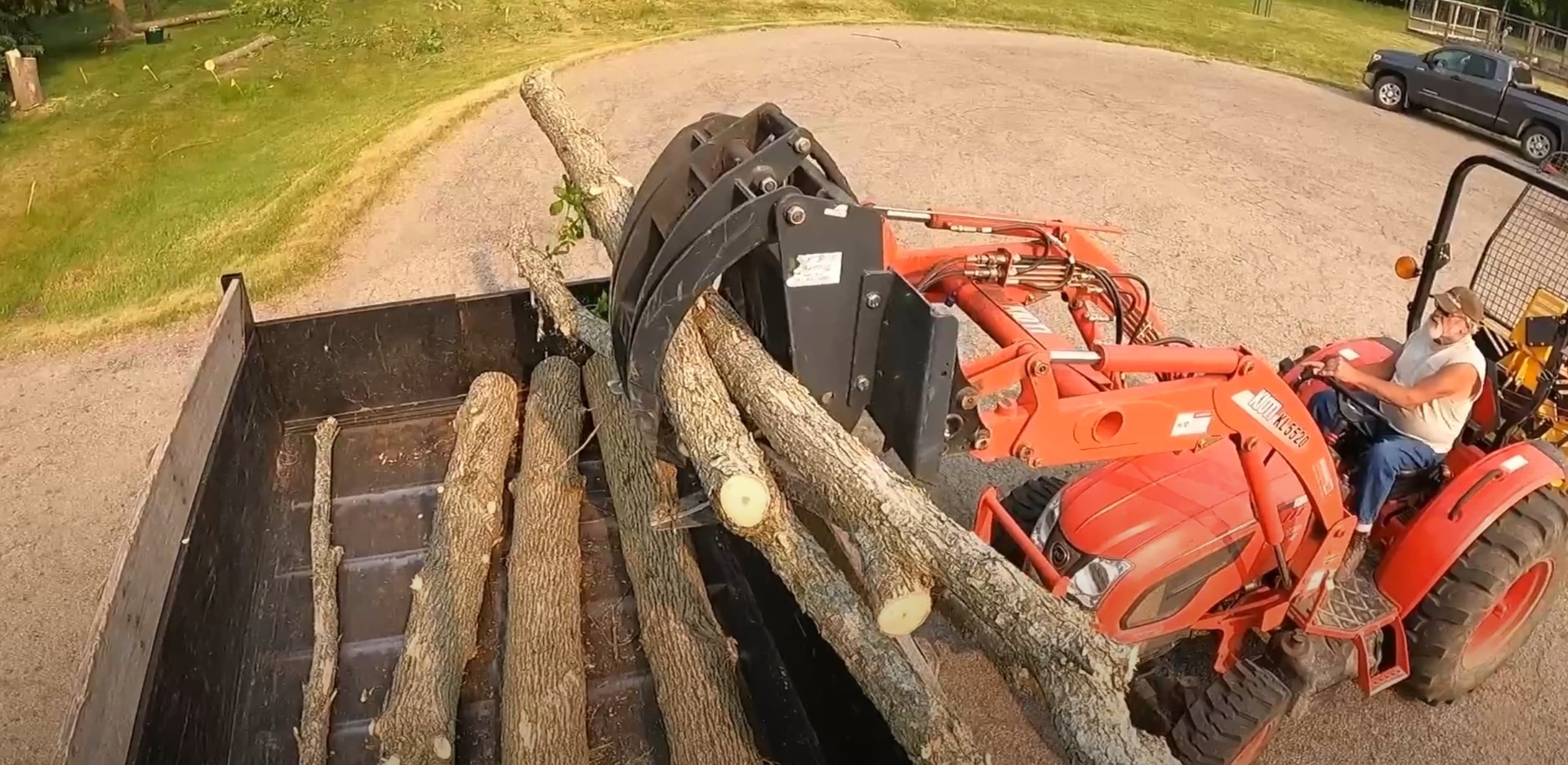 Professional tree service equipment loading cut logs for removal